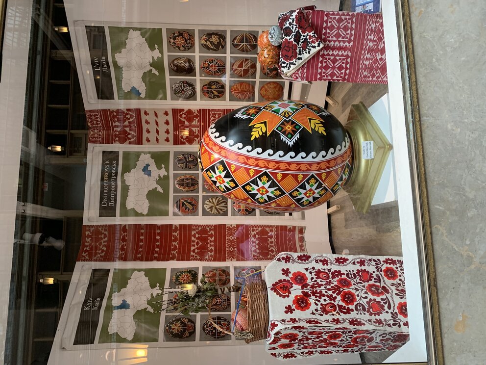 a display of a window with a decorated egg and boxes