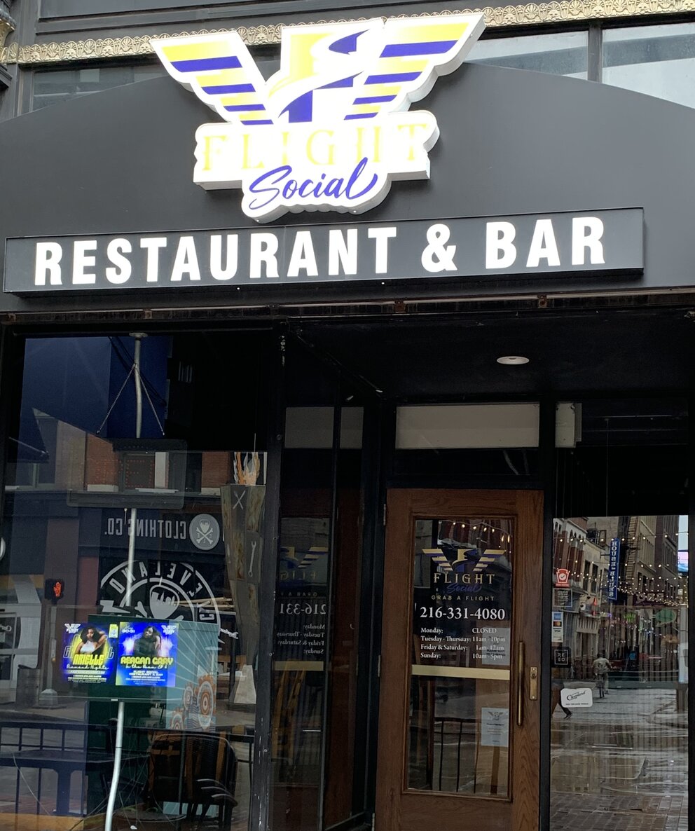 a restaurant with a sign on the front